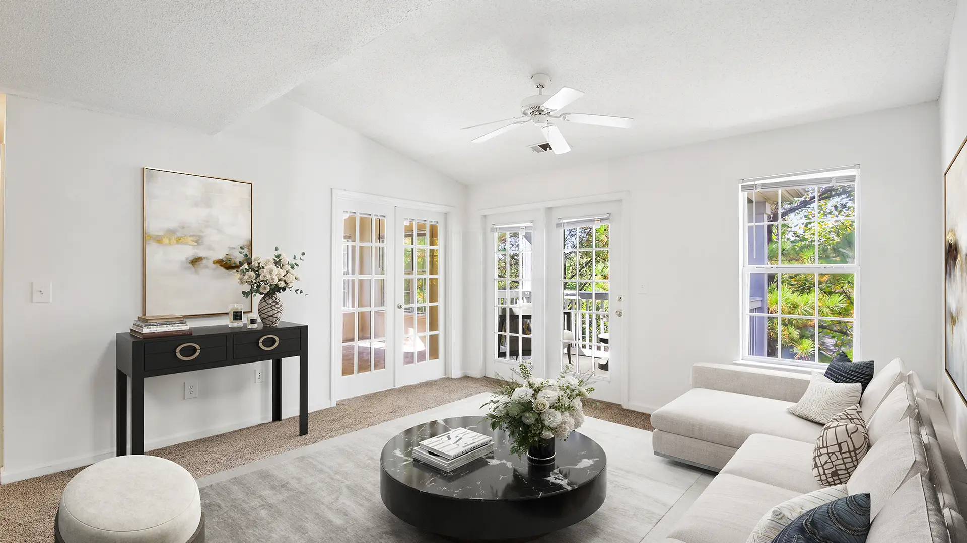 Model living room with two french doors leading to the balcony