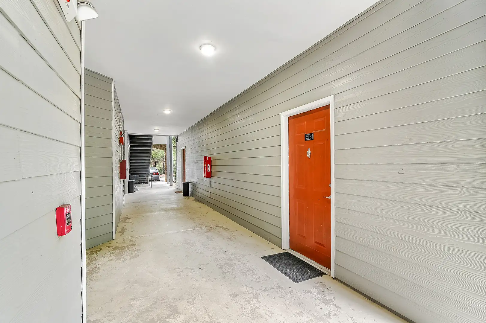 apartment hallway with orange door