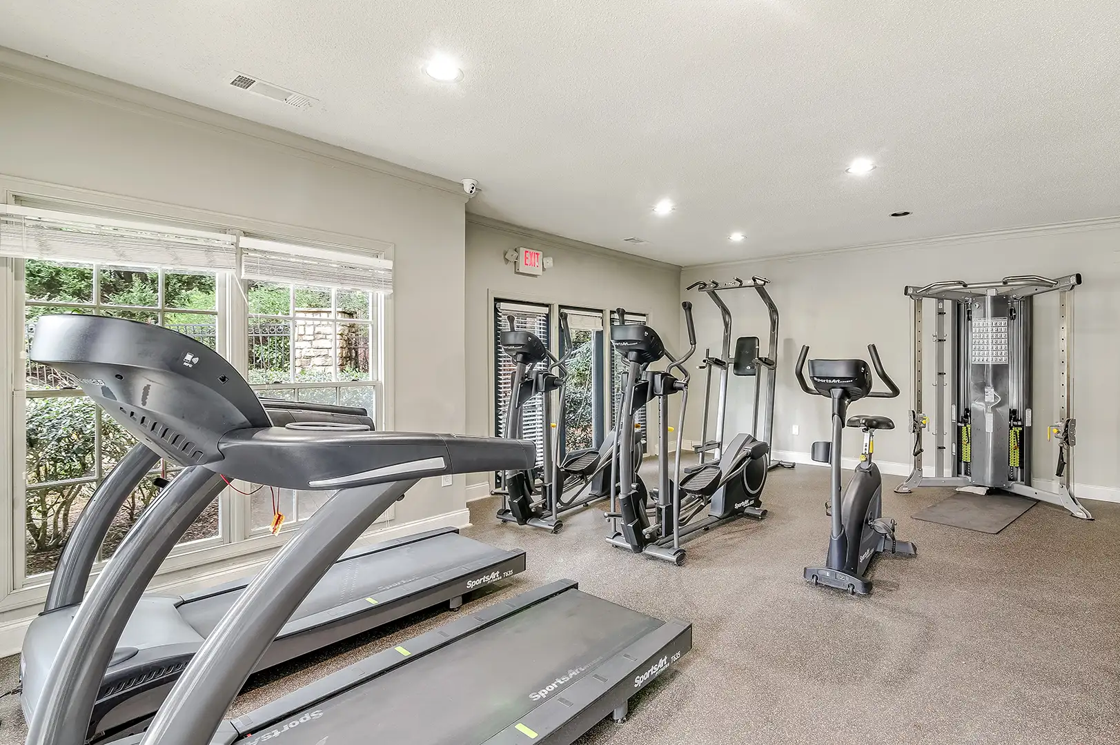 Fitness center with stationary bikes, treadmills, ellipticals, and weight lifting machines.