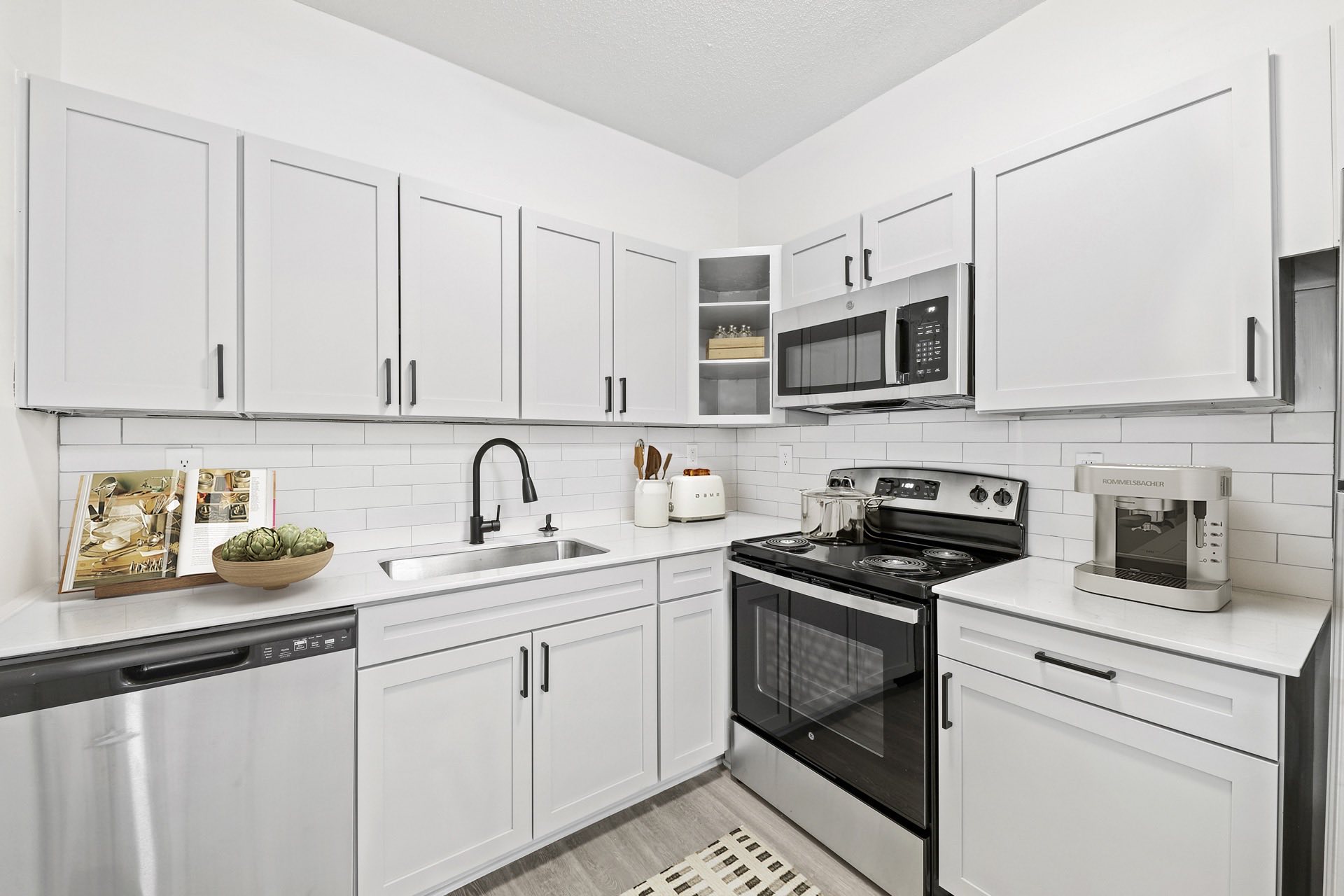 Kitchen with white shaker cabinets and stainless steel appliances