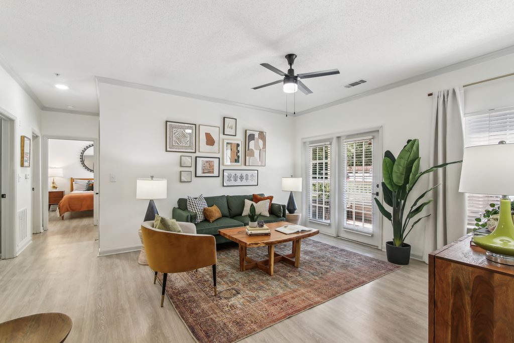 Renovated living room with furniture and wood-style flooring.
